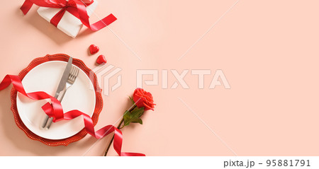 Valentines day table place setting with red rose, two hearts. 95881791