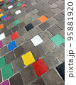 coloured tiles on a pavement in a downfacing perspective 95881920