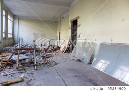 Broken floor, trash and clutter in an abandoned room Broken floor, trash and clutter in an abandoned room 95884900