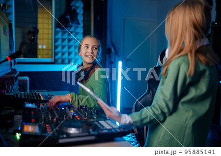 Children making music at radio station or record studio 95885141