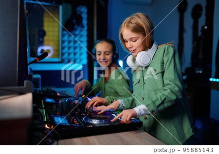 Children using sound mixer in radio station 95885143