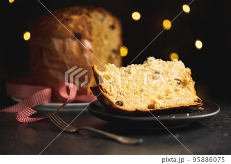 Panettone Christmas Cake. Italian sweet bread on plate on dark table. Panettone Christmas Cake. Italian sweet bread on plate on dark table. 95886075