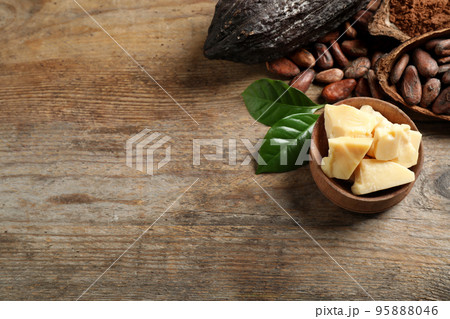 Composition with organic cocoa butter on wooden table, above view. Space for text 95888046