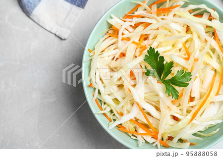 Tasty salad with cabbage and carrot on light grey marble table, top view Tasty salad with cabbage and carrot on light grey marble table, top view 95888058