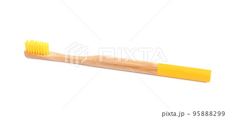 Bamboo toothbrush with yellow bristle isolated on white Bamboo toothbrush with yellow bristle isolated on white 95888299