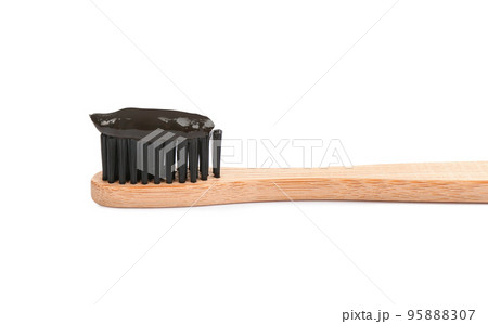 Bamboo toothbrush with charcoal paste isolated on white Bamboo toothbrush with charcoal paste isolated on white 95888307