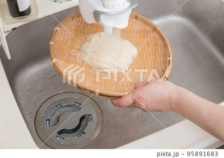 【ミドル主婦が茹で上がった素麺を流水で冷やす】 95891683