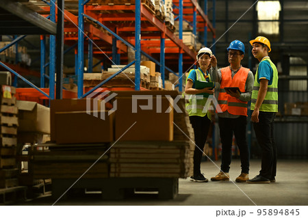 Warehouse workers working in the retail warehouse full of shelves with goods. Manufacture storehouse occupation concept 95894845
