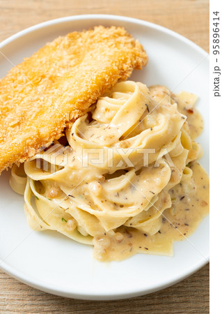 fettuccine pasta white cream sauce with fried fish fettuccine pasta white cream sauce with fried fish 95896414