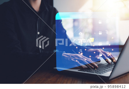 Document Management System (DMS). Digital online document database and paperless office. Businessman hand typing notebook (Laptop) with process automation to efficiently manage files. Document Management System (DMS). Digital online document database and paperless office. Businessman hand typing notebook (Laptop) with process automation to efficiently manage files. 95898412