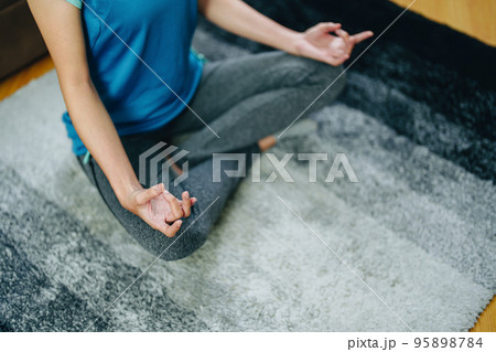 stress relief, muscle relaxation, breathing exercises, exercise, meditation, portrait of Young Asian woman relaxing her body from office work by practicing yoga by watching online tutorials. 95898784