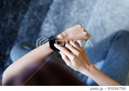 Health care, heart rate monitor, portrait of Asian beautiful woman using smart watch to select health programs such as yoga, cardio exercises, breathing meditation. to prepare before the activity. 95898786