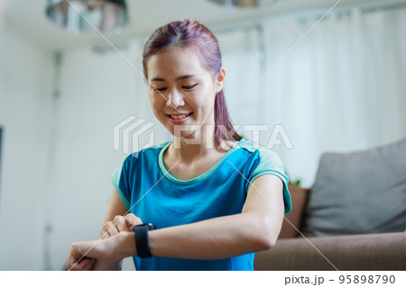 Health care, heart rate monitor, portrait of Asian beautiful woman using smart watch to select health programs such as yoga, cardio exercises, breathing meditation. to prepare before the activity. Health care, heart rate monitor, portrait of Asian beautiful woman using smart watch to select health programs such as yoga, cardio exercises, breathing meditation. to prepare before the activity. 95898790