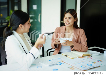 female marketing and sales employee talking and taking a coffee break 95899017