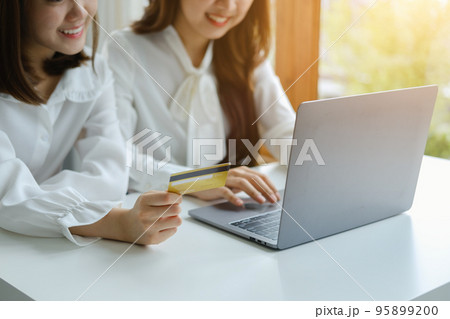 Online Shopping and Internet Payments, Beautiful Asian women are using their credit cards and computer laptop to shop online or conduct errands in the digital world. Online Shopping and Internet Payments, Beautiful Asian women are using their credit cards and computer laptop to shop online or conduct errands in the digital world. 95899200