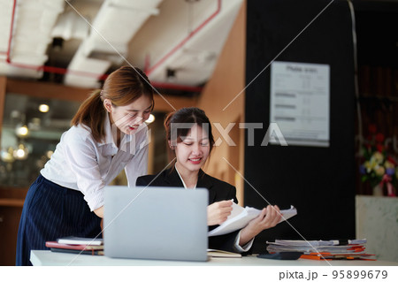 A portrait of two young Asian businesswoman plan marketing strategies and investments to profit from their clients. 95899679