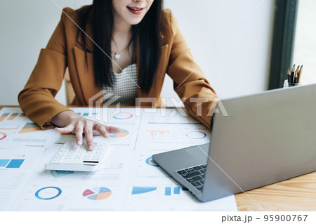 financial, Planning, Marketing and Accounting, portrait of Asian employee checking financial statements using documents and calculators at work.. 95900767