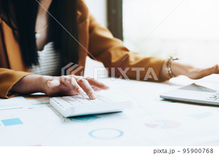 financial, Planning, Marketing and Accounting, portrait of Asian employee checking financial statements using documents and calculators at work.. 95900768