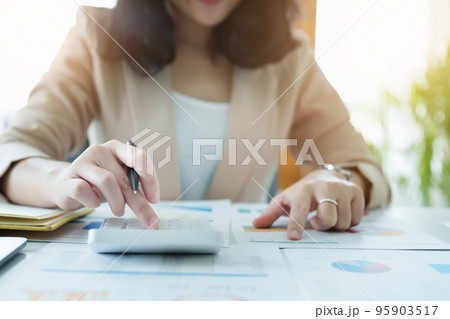 Accountants, Asian auditors are using calculators and computers to review annual tax budgets to submit information to the IRS Accountants, Asian auditors are using calculators and computers to review annual tax budgets to submit information to the IRS 95903517