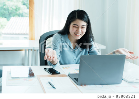 Portrait of a beautiful Asian teenage girl using computer for video conferencing at office. Portrait of a beautiful Asian teenage girl using computer for video conferencing at office. 95903521