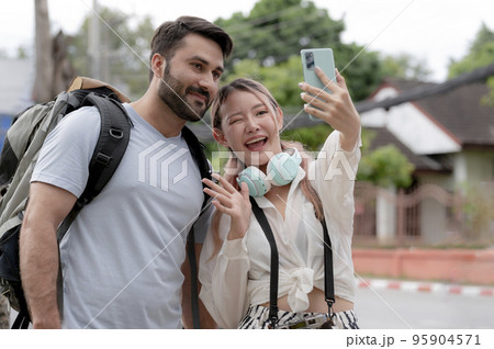 Young couples of different nationalities take selfies while traveling together. Young couples of different nationalities take selfies while traveling together. 95904571