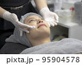 Young women facials from beauty experts. 95904578