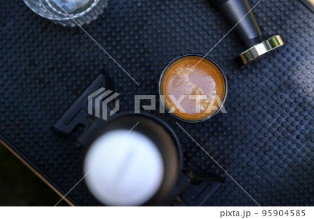 Beautiful crema coffee in a glass. 95904585