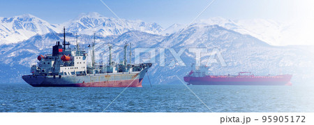 large fishing vessel on the background of hills and volcanoes. Selective focus large fishing vessel on the background of hills and volcanoes. Selective focus 95905172