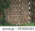 wall made with terracotta bricks arranged diagonally to create vent holes in an old farm 95906363