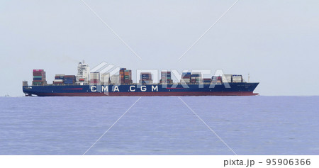Big Container cargo ship leaving port after loading unloading operations Big Container cargo ship leaving port after loading unloading operations 95906366