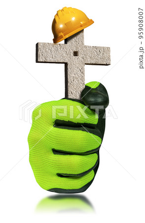 Gloved Hand Holding an Orange and Yellow Safety Helmet on a Stone Cross Gloved Hand Holding an Orange and Yellow Safety Helmet on a Stone Cross 95908007