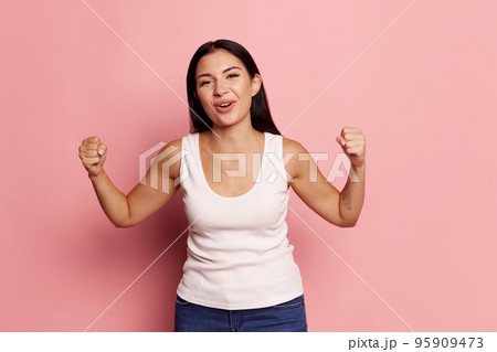 I won. Winning success happy woman celebrating being a winner. Dynamic image of caucasian female model on pink studio background. Victory, delight concept. Human facial emotions concept. I won. Winning success happy woman celebrating being a winner. Dynamic image of caucasian female model on pink studio background. Victory, delight concept. Human facial emotions concept. 95909473