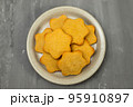 butter cookies isolated on light brown plate 95910897