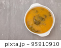 vegetable soup with crackers in white bowl on ceramic 95910910