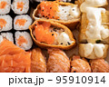 Assorted sushi nigiri and maki set. A variety of Japanese sushi with tuna, crab, salmon and rolls. 95910914