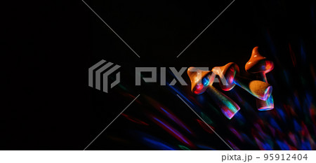 Psilocybin therapy as treatment of mental health challenges. psilocybin psychotropic magic psilocybin mushrooms on dark neon background Psilocybin therapy as treatment of mental health challenges. psilocybin psychotropic magic psilocybin mushrooms on dark neon background 95912404