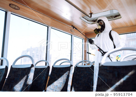 Cleaning and Disinfection transport. Man in protective suit washing , disinfection public transport 95913704
