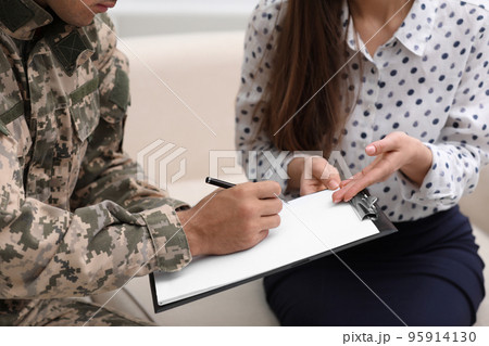Male military officer filling form in psychotherapist office, closeup Male military officer filling form in psychotherapist office, closeup 95914130