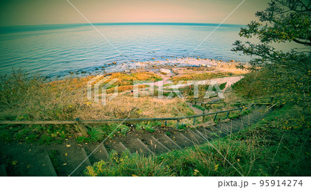 Down stairs path to the beach of Cape Arkona chalk cliff at Baltic sea Down stairs path to the beach of Cape Arkona chalk cliff at Baltic sea 95914274