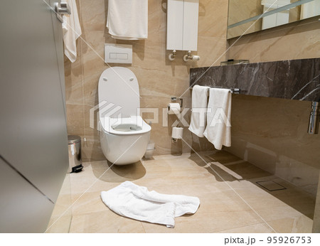 Carelessly abandoned in need of replacement on a hotel bathroom floor Carelessly abandoned in need of replacement on a hotel bathroom floor 95926753