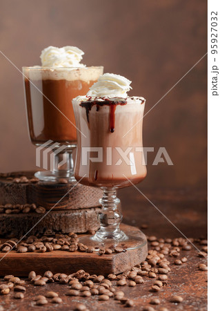 Coffee and chocolate drinks with whipped cream. 95927032