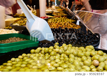 baskets with different olives on the counter 95928597
