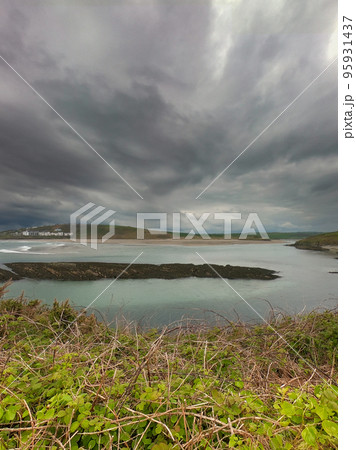 View of Clonakilty Bay on a cloudy day. Gloomy sky over the seashore. Beautiful seascape. The coastline of the south of Ireland, County Cork. View of Clonakilty Bay on a cloudy day. Gloomy sky over the seashore. Beautiful seascape. The coastline of the south of Ireland, County Cork. 95931437