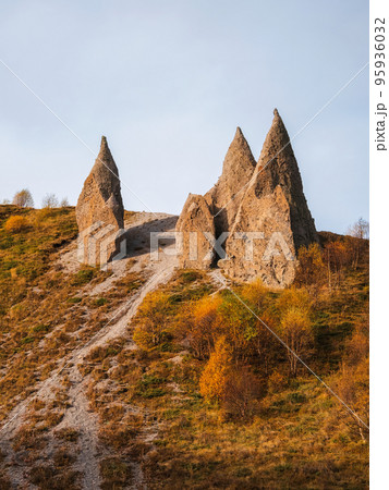 Autumn rocks "Dragon's Teeth" in the tract Jila-Su. Awesome scenic mountain landscape with big cracked pointed stones closeup in sunlight. Sharp rocks background. 95936032