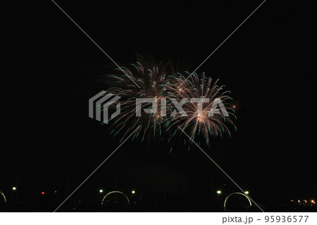 Multicolored fireworks in the dark sky, city day celebration. Multicolored fireworks in the dark sky, city day celebration. 95936577