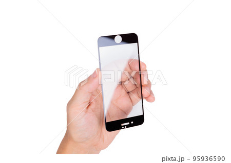 The hand holds a protective screen for a mobile phone. White background. Close-up. The hand holds a protective screen for a mobile phone. White background. Close-up. 95936590