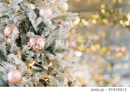 Christmas tree decorated with golden balls. Merry christmas card. New Year decoration on bokeh backdrop. Copy space. Christmas tree decorated with golden balls. Merry christmas card. New Year decoration on bokeh backdrop. Copy space. 95939812