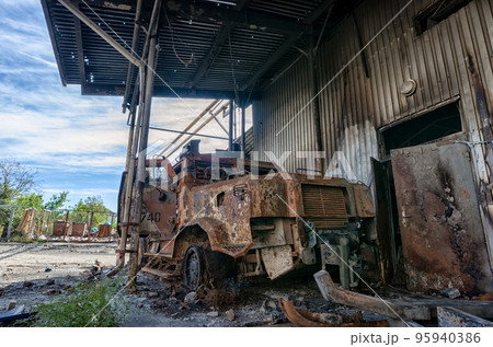 burnt military armored car on the street of the ruined city 95940386