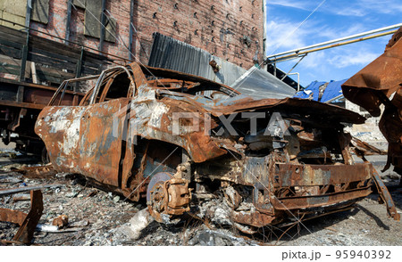 burnt car on the street of the ruined city burnt car on the street of the ruined city 95940392