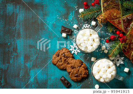 Hot Chocolate with Marshmallows and Homemade Chocolate Chip Cookies on a blue stone or concrete table. Top view flat lay background. Copy space. 95941915